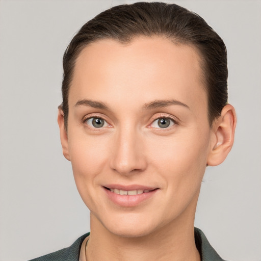 Joyful white young-adult female with short  brown hair and grey eyes