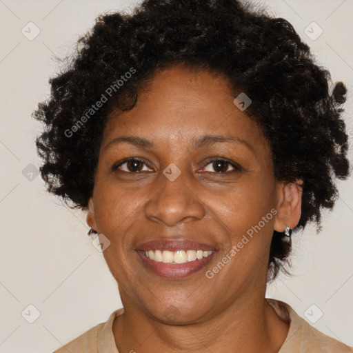 Joyful black adult female with short  brown hair and brown eyes