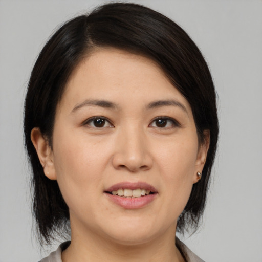 Joyful white young-adult female with medium  black hair and brown eyes