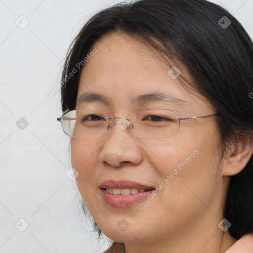 Joyful white adult female with medium  brown hair and brown eyes