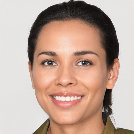 Joyful latino young-adult female with medium  black hair and brown eyes