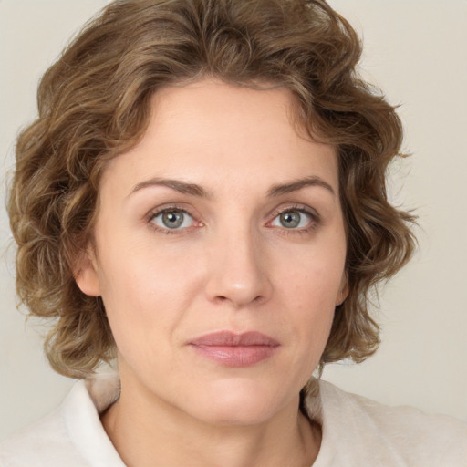 Joyful white young-adult female with medium  brown hair and green eyes