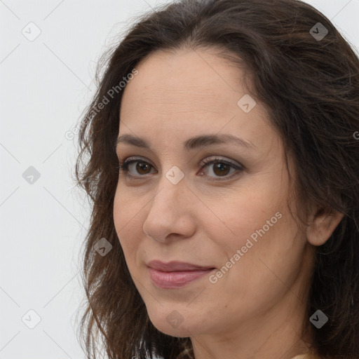 Joyful white adult female with long  brown hair and brown eyes