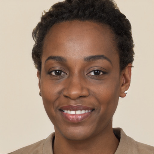 Joyful black young-adult female with short  brown hair and brown eyes