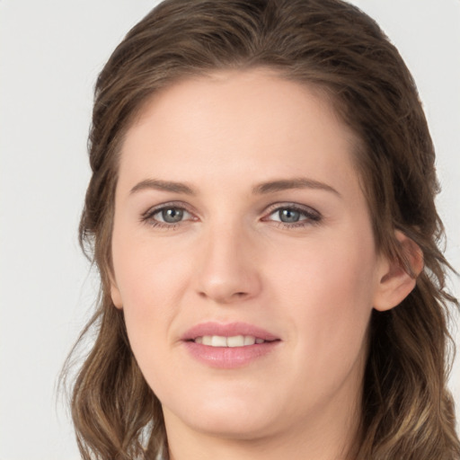 Joyful white young-adult female with long  brown hair and grey eyes