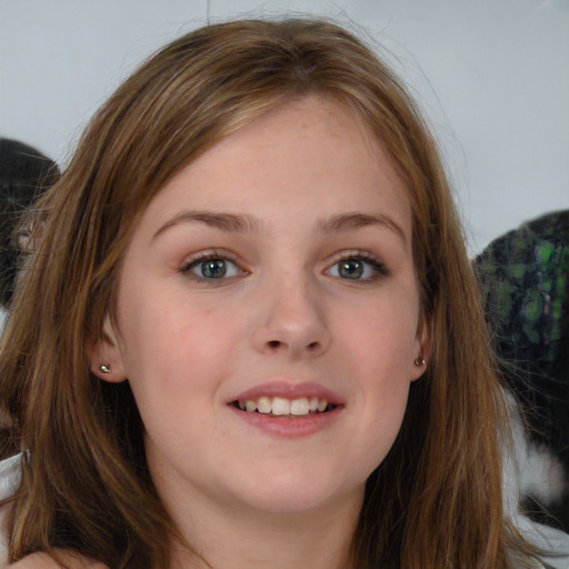 Joyful white child female with long  brown hair and brown eyes