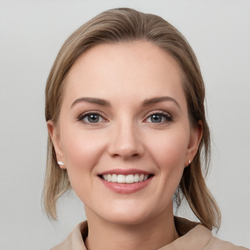 Joyful white young-adult female with medium  brown hair and grey eyes