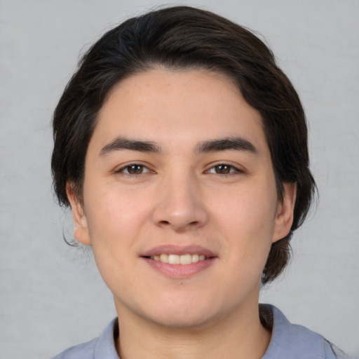 Joyful white young-adult male with medium  brown hair and brown eyes