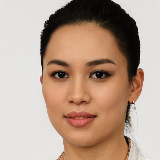 Joyful latino young-adult female with short  black hair and brown eyes