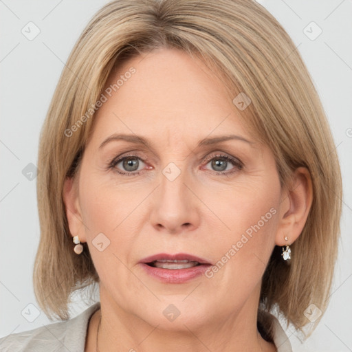 Joyful white adult female with medium  brown hair and grey eyes