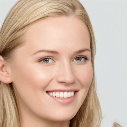 Joyful white young-adult female with long  brown hair and blue eyes