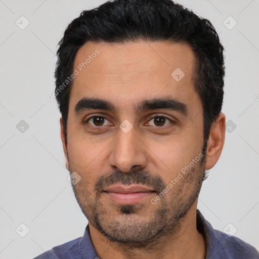 Joyful latino young-adult male with short  black hair and brown eyes