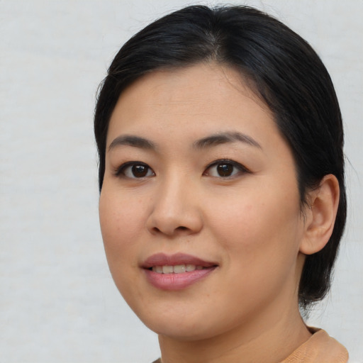 Joyful asian young-adult female with medium  black hair and brown eyes