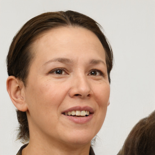 Joyful white adult female with short  brown hair and brown eyes