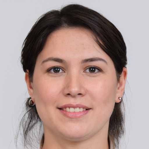 Joyful white young-adult female with medium  brown hair and brown eyes