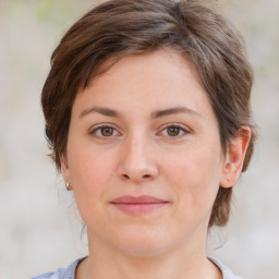 Joyful white young-adult female with medium  brown hair and green eyes