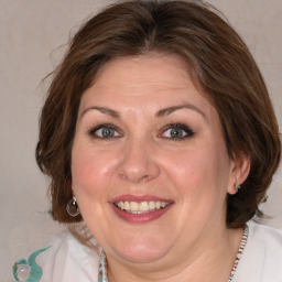 Joyful white adult female with medium  brown hair and blue eyes