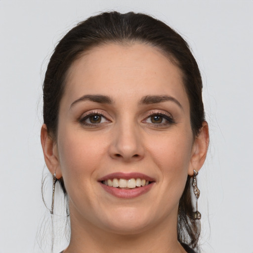 Joyful white young-adult female with long  brown hair and grey eyes