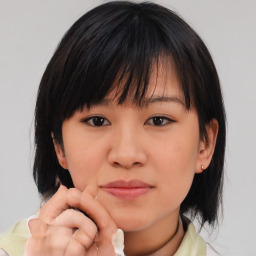 Neutral asian young-adult female with medium  brown hair and brown eyes