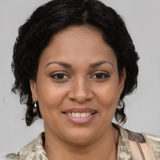 Joyful latino adult female with medium  brown hair and brown eyes