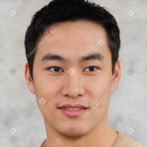 Joyful asian young-adult male with short  brown hair and brown eyes