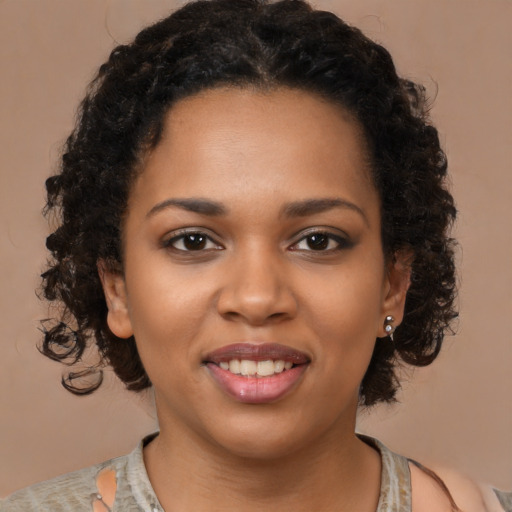 Joyful black young-adult female with medium  brown hair and brown eyes