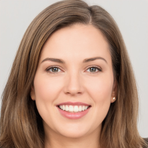 Joyful white young-adult female with long  brown hair and brown eyes