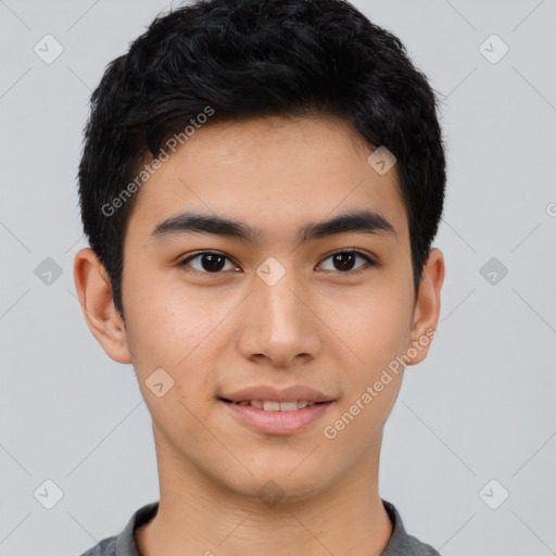 Joyful asian young-adult male with short  black hair and brown eyes