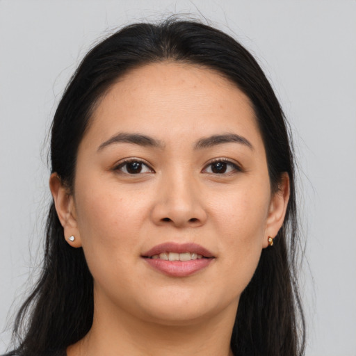 Joyful asian young-adult female with long  brown hair and brown eyes