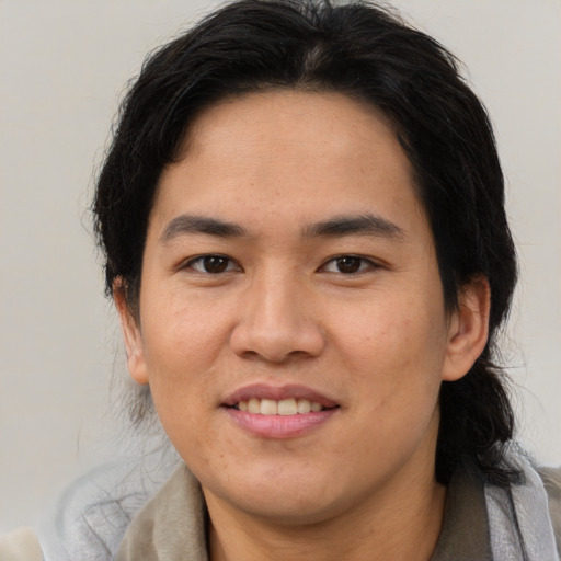 Joyful asian adult female with medium  brown hair and brown eyes