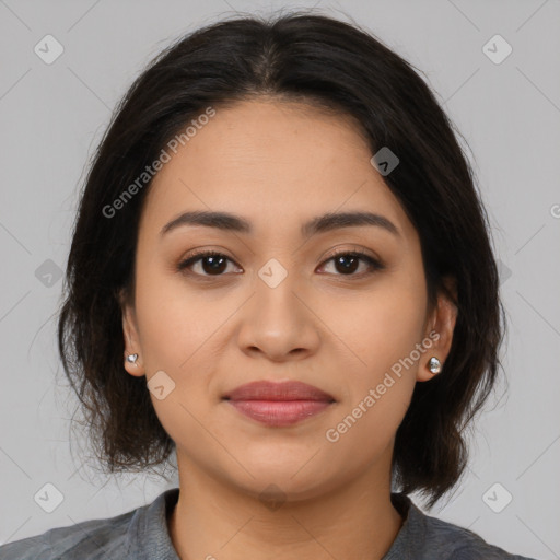 Joyful latino young-adult female with medium  brown hair and brown eyes