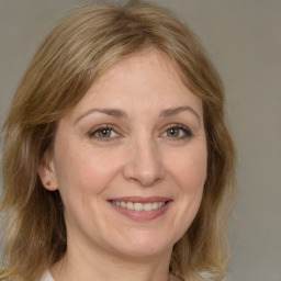 Joyful white adult female with medium  brown hair and grey eyes