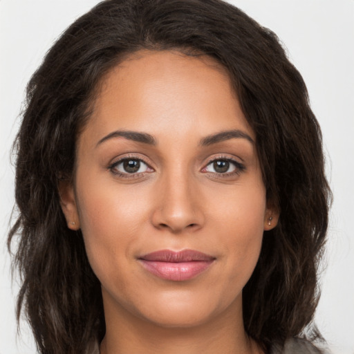 Joyful white young-adult female with long  brown hair and brown eyes