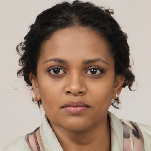 Neutral black young-adult female with medium  brown hair and brown eyes