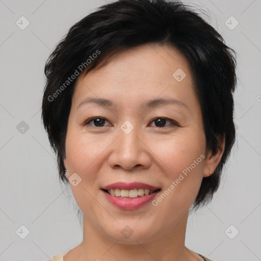 Joyful asian adult female with medium  brown hair and brown eyes