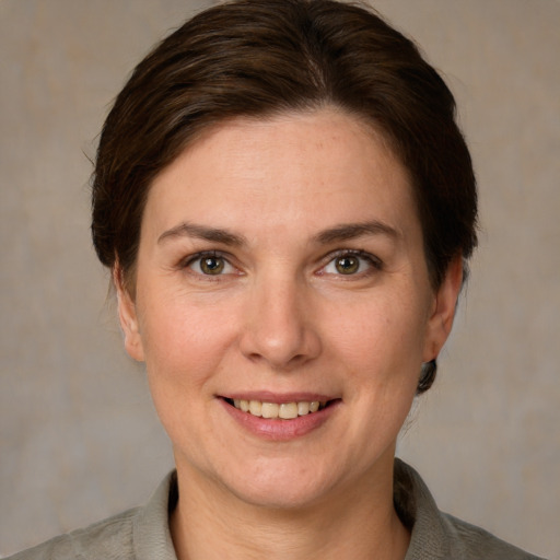 Joyful white adult female with short  brown hair and grey eyes