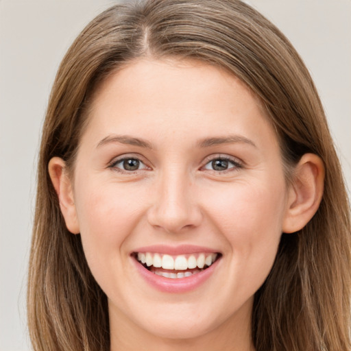 Joyful white young-adult female with long  brown hair and grey eyes