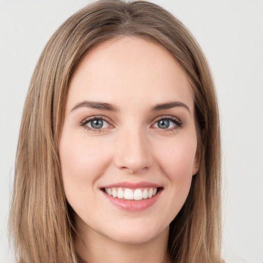 Joyful white young-adult female with long  brown hair and green eyes