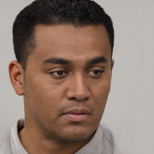 Neutral latino young-adult male with short  black hair and brown eyes