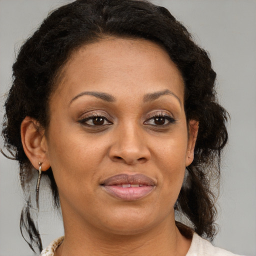 Joyful latino adult female with medium  brown hair and brown eyes