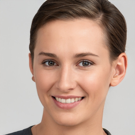 Joyful white young-adult female with short  brown hair and brown eyes