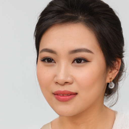 Joyful asian young-adult female with medium  brown hair and brown eyes