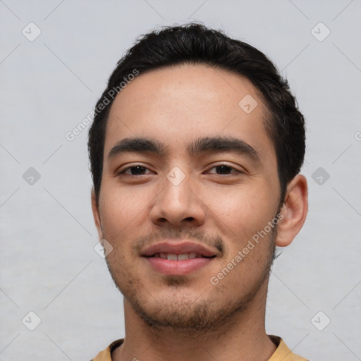 Joyful white young-adult male with short  black hair and brown eyes