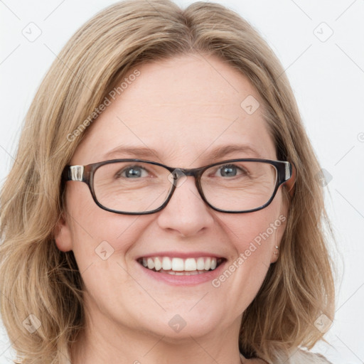 Joyful white adult female with medium  brown hair and blue eyes