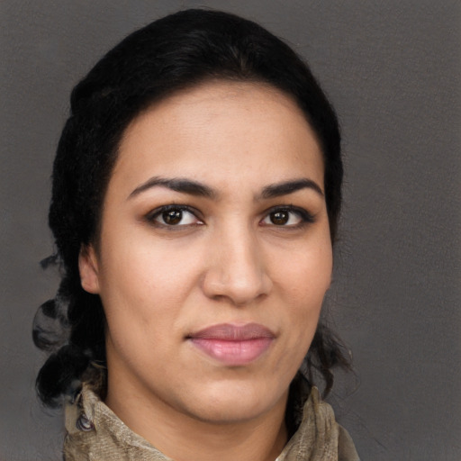 Joyful latino young-adult female with medium  brown hair and brown eyes