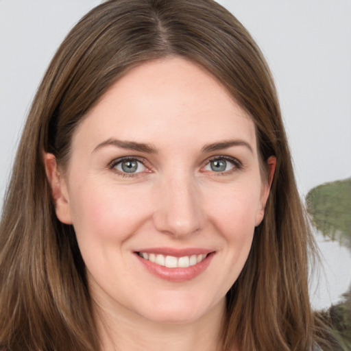 Joyful white young-adult female with long  brown hair and grey eyes