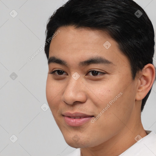 Joyful asian young-adult male with short  black hair and brown eyes