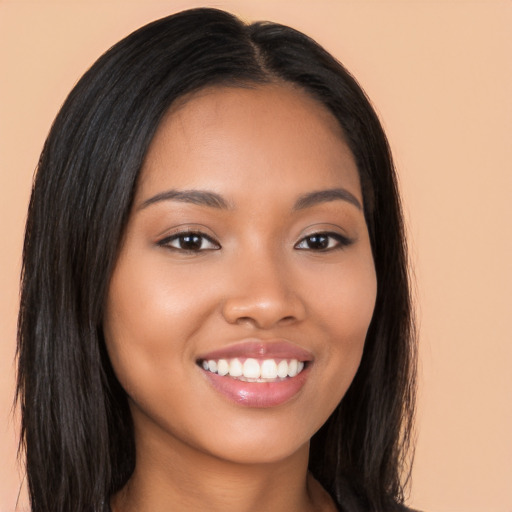 Joyful latino young-adult female with long  brown hair and brown eyes