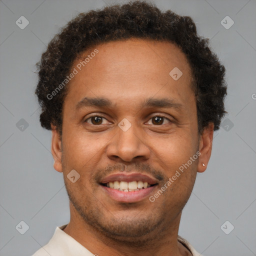 Joyful latino young-adult male with short  brown hair and brown eyes