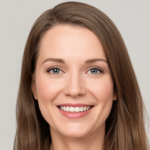 Joyful white young-adult female with long  brown hair and grey eyes